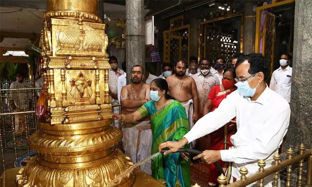 TTD JEO Basanth Kumar cleaning Dhwaja Sthambham at Goddess Padmavathi temple at Tiruchanur as part of Koil Alwar Tirumanjanam on Tuesday