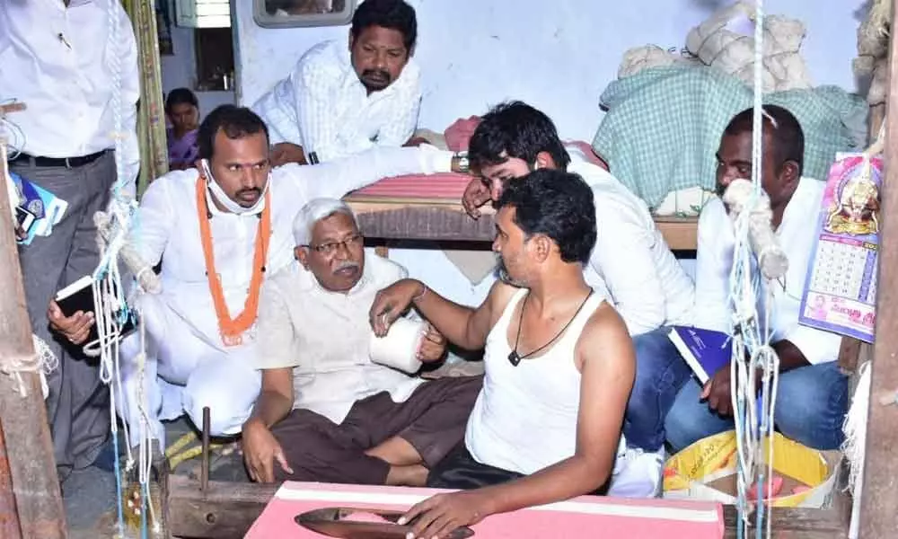 Telangana Jana Samithi (TJS) chief Prof Kodandaram interacting with a weaver in Warangal on Tuesday