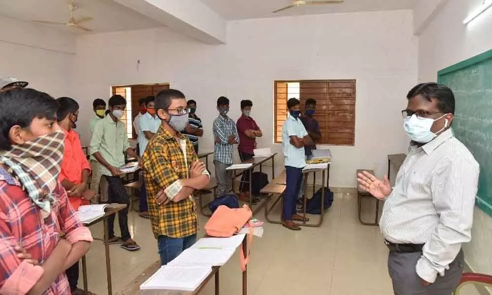 District Collector I Samuel Anand Kumar giving suggestions to the students at Jalagam Rama Rao Memorial Municipal Corporation High School in Guntur on Tuesday