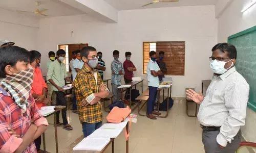 District Collector I Samuel Anand Kumar giving suggestions to the students at Jalagam Rama Rao Memorial Municipal Corporation High School in Guntur on Tuesday