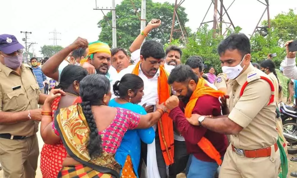 Locals preventing the police from arresting BJP leaders at Venugopal Nagar in Khammam on Wednesday