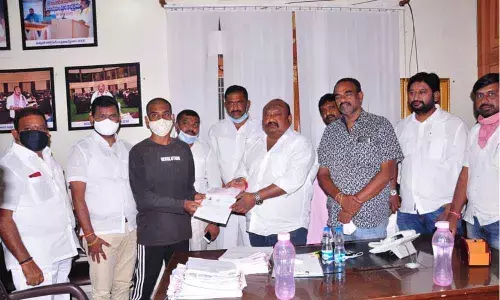 BC Welfare Minister Gangula Kamalakar presenting CMRF cheque to a beneficiary at his camp office in Karimnagar