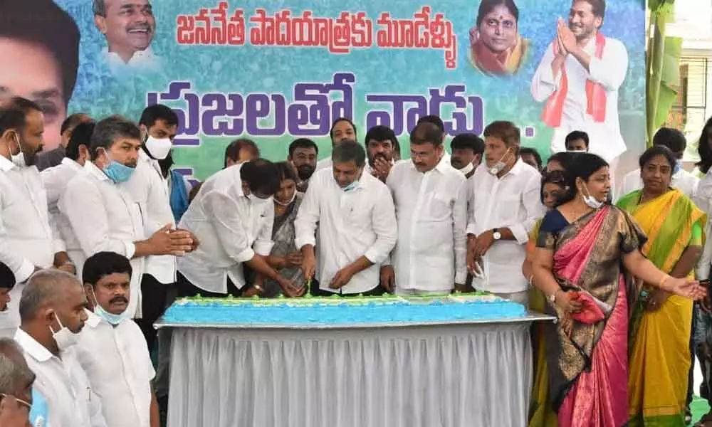 YSRCP leaders and Ministers cutting a cake marking the third anniversary of start of Praja Sankalpa Yatra by party president and Chief Minister Y S Jagan Mohan Reddy, at party state headquarters in Tadepalli on Friday
