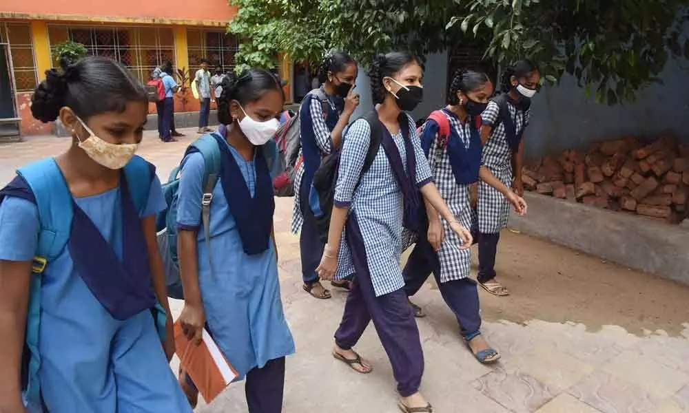 Armed with masks, students head to their classes at GVMC High School in Visakhapatnam  	Photo: A Pydiraju