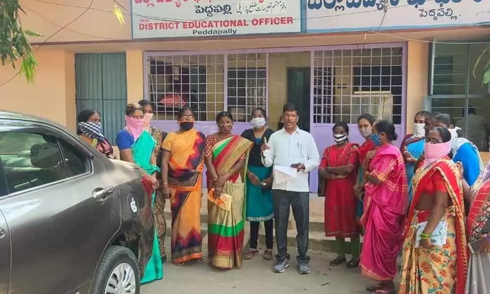 Model School Hostel workers staging protest at DEO office in Peddapalli on Saturday