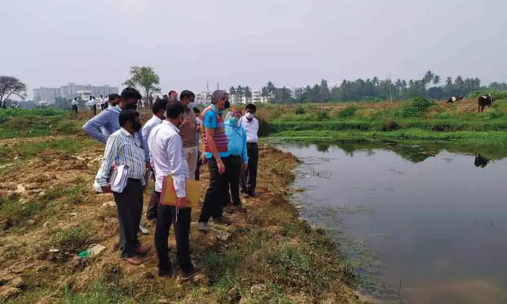 Members of the monitoring committee inspecting the lake