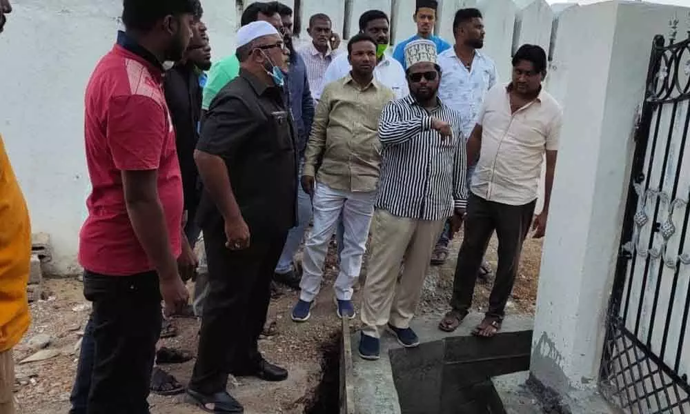 AIMIM leaders inspecting a side drain constructed on Edgah land at Saleh Nagar in Karimnagar on Monday