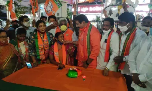 Leaders celebrating party victory by distributing sweets in Rajamahendravaram on Tuesday