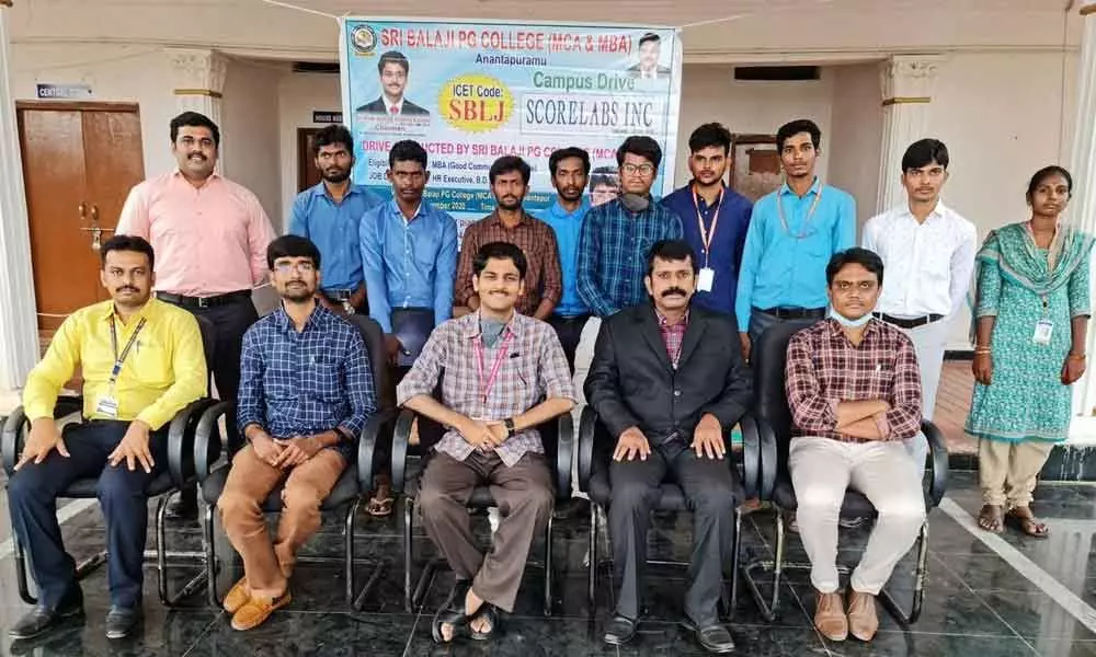 Sri Balaji PG College (MCA) Principal C Manmadeswara Reddy poses with selected students in campus placements in Hyderabad-based firm, in Rudrampet on Wednesday. College Chairman Palle Krishna Kishore Reddy congratulated the students