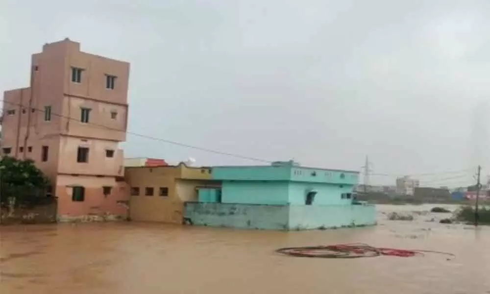 RTC Colony on the outskirts of Nellore city. (Inset) Nellore RDO Hussain Saheb taking stock of rain situation