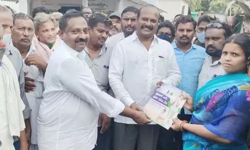 YSRCP leader Amamnchi Swamulu explaining the welfare schemes to people in Chirala mandal on Friday