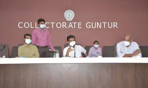 Joint Collector AS Dinesh Kumar addressing meeting of Revenue Officers in Guntur on Friday. Joint Collector (Asara) Sreedhar Reddy also seen