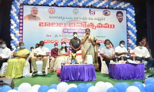 Minister Mekathoti Sucharita addressing a meeting in Guntur on Saturday on the occasion of Childrens Day. MLAs Maddali Giridhara Rao, Mustafa also seen