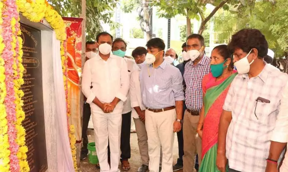 MLA B Karunakar Reddy inaugurating a new drainage system built at a cost of  Rs 2.44 cr in Tirupati on Monday. Municipal Commissioner  P S Girisha and others are seen.