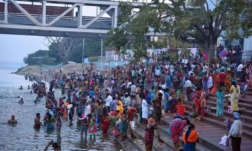 Devotees taking holy dip in River Godavari at Pushkar Ghat in Rajamahendravaram on Monday
