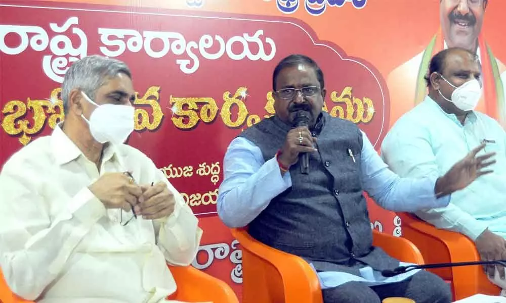 BJP state president and MLC Somu Veerraju, Tobacco Board chariman Yadlapati Raghunatha Babu and party leaders addressing a press conference at new state party office in Vijayawada on Monday