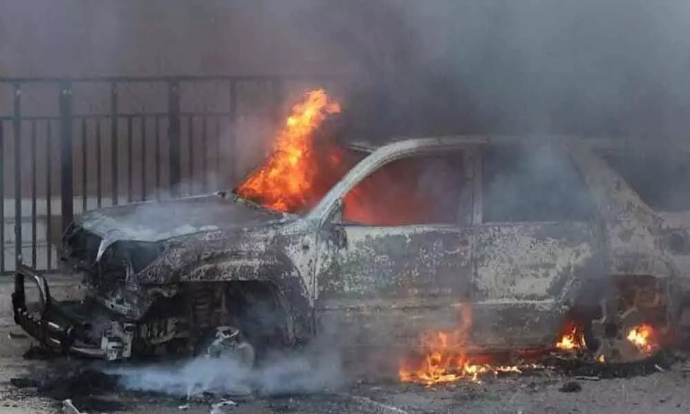 A driver, trapped in his car, was charred to death when the vehicle caught fire after crashing into a minibus on the Karnal-Meerut Highway in Shamli district.