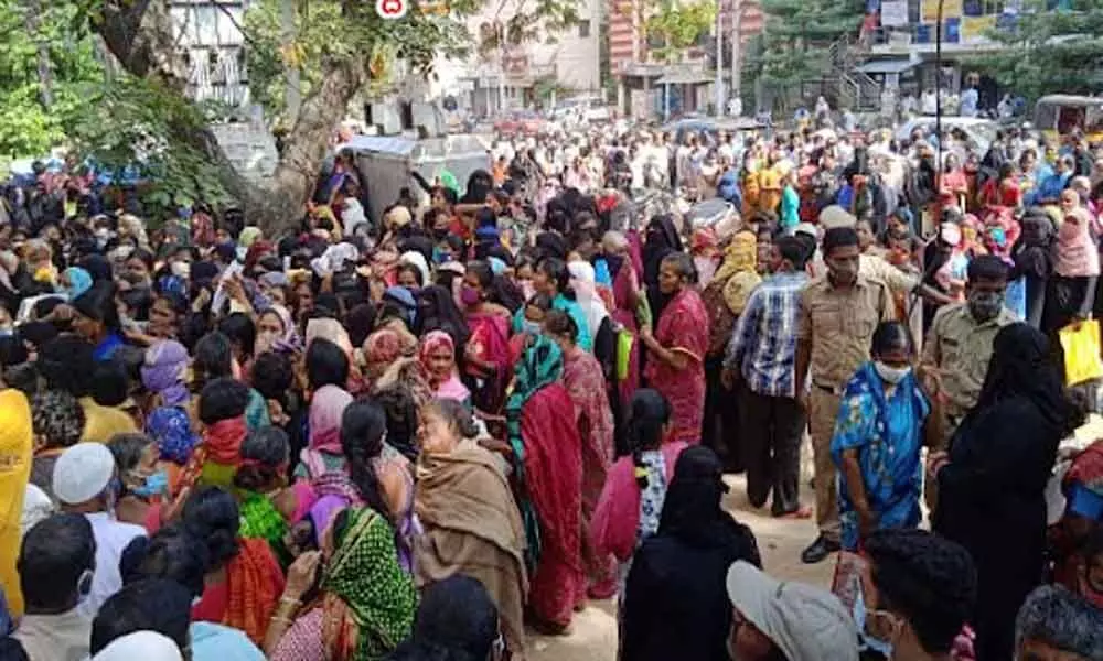 People queue up at Mee-Seva centres in Hyderabad for flood aid