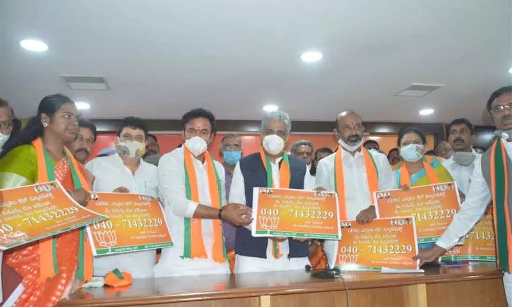 Bharatiya Janata Party national general secretary Bhupender Yadav along with Union Minister G Kishan Reddy and TS BJP President B Sanjay Kumar releasing BJP manifesto poster in Hyderabad on Wednesday