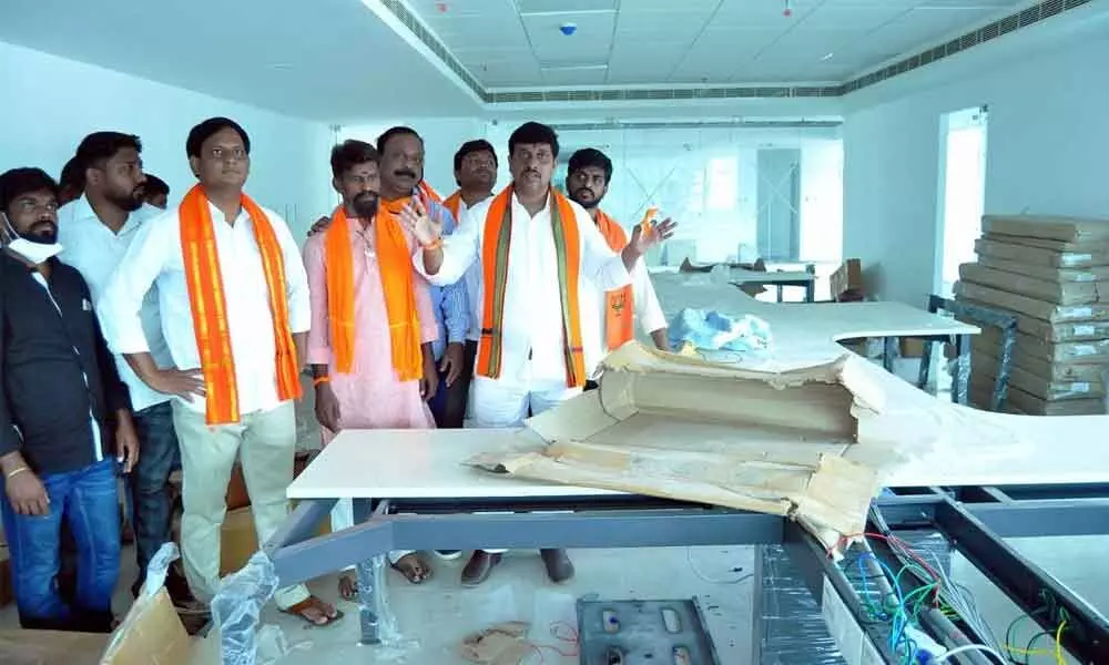 BJP district chief Galla Satyanarayana along with party leaders inspecting the IT Hub construction works in Khammam on Thursday