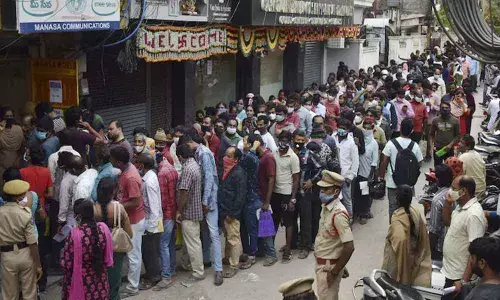 A woman died in a commotion while standing in queues at Mee-Seva centre at Golconda for 10,000 financial aid for flood victims.