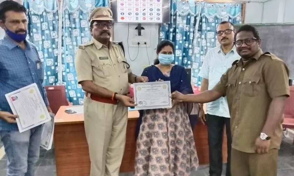 RM Vijaya Geetha and RTO Chandrasekhar Reddy handing over certificates to RTC trained drivers in Ongole on Friday