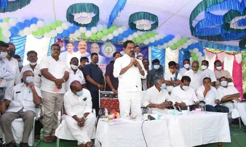 Deputy Chief Minister K Narayanaswamy addressing a meeting in Penumuru on Sunday. Panchayat Raj Minister Peddireddy Ramachandra Reddy and others are also seen