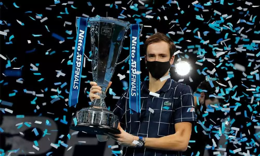 Daniil Medvedev of Russia holds up the winners trophy as confetti falls after defeating Dominic Thiem of Austria in the final of the ATP World Finals tennis match at the ATP World Finals tennis tournament at the O2 arena in London