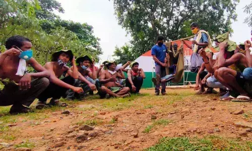 Tribals staging a protest at the Gandhi statue near GVMC office in Visakhapatnam on Monday