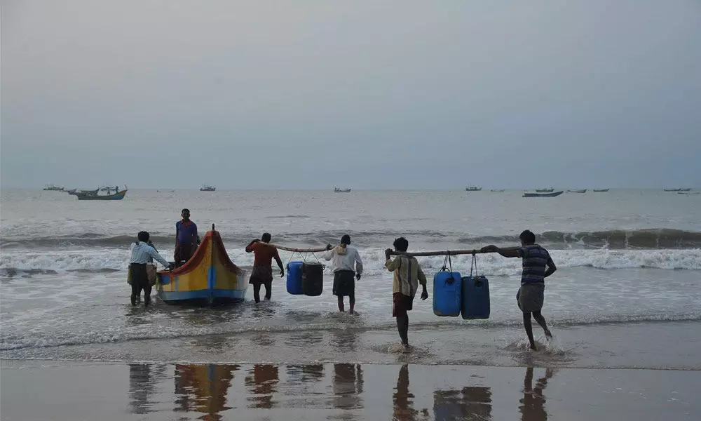 Fishermen entering sea for fishing at Vadarevu