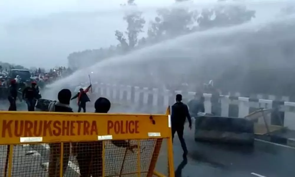 Protesting farmers face water cannons in Haryana, manage to move ahead