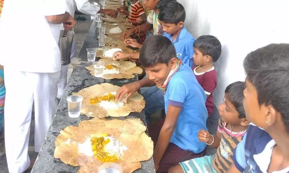 Sai Prasadam being served to children in a village in Anantapur