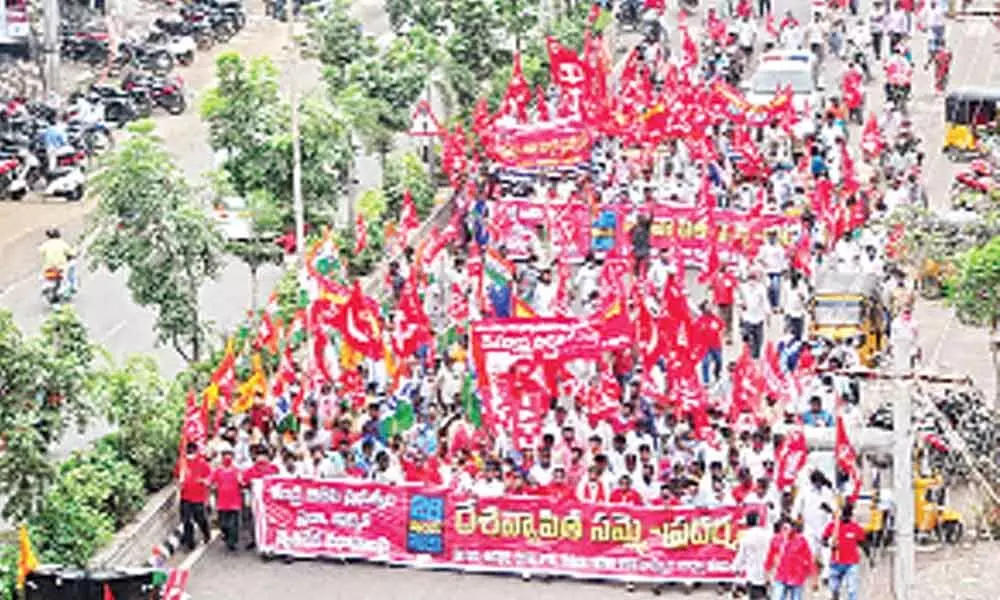 Members of various trade unions taking out a huge rally in Khammam on Thursday