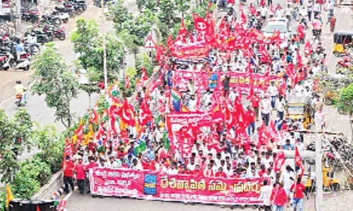 Members of various trade unions taking out a huge rally in Khammam on Thursday