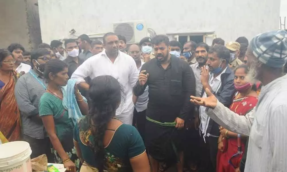 Ministers Anil Kumar Yadav and Goutham Reddy interacting with the flood-hit victims at Bhagat Singh Colony in Nellore on Sunday
