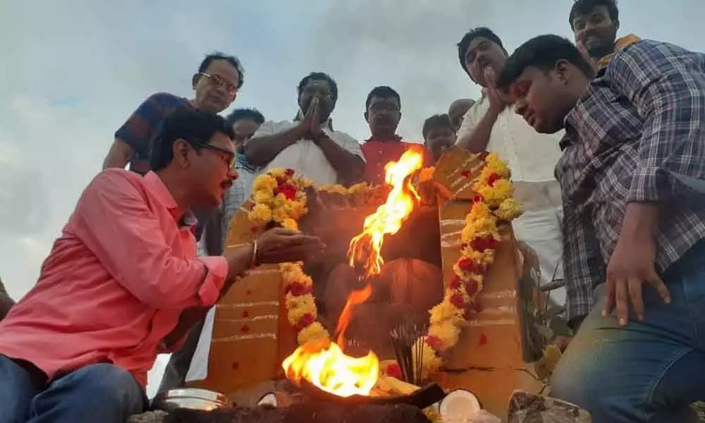 Gandla community members lighting the Karthika Deepam, on the upper reach of Kapilatheertham waterfalls on Tirumala hills here on Sunday