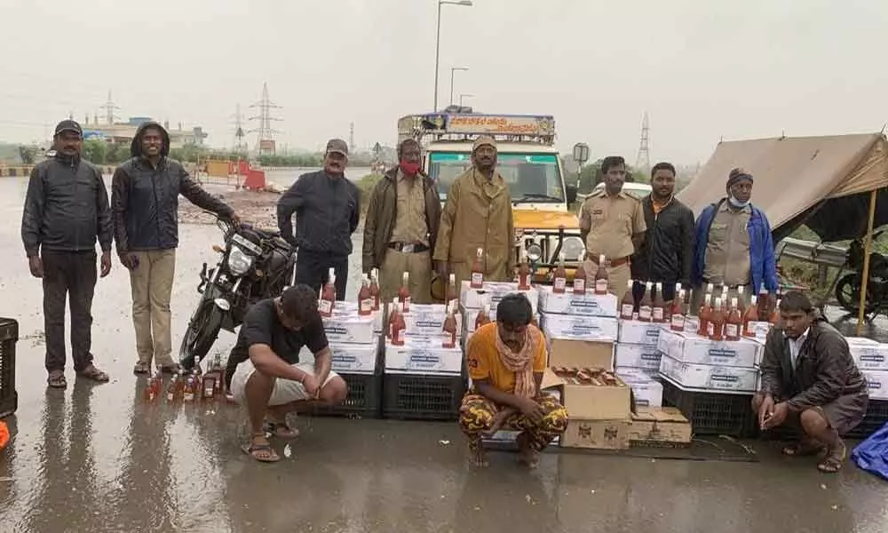 SEB cops produce seized IMFL liquor and accused before media at Panchalingala border check post on Sunday