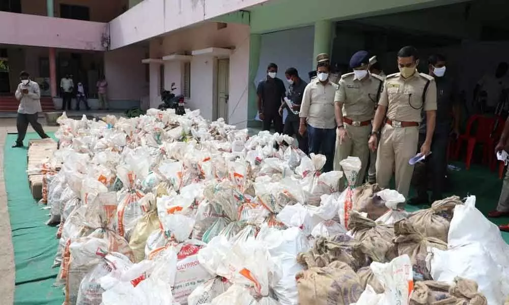 SP Vishal Gunni showing seized spurious liquor to the media in Guntur on Sunday