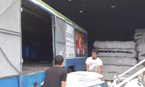 Workers loading cargo into DGT vehicle