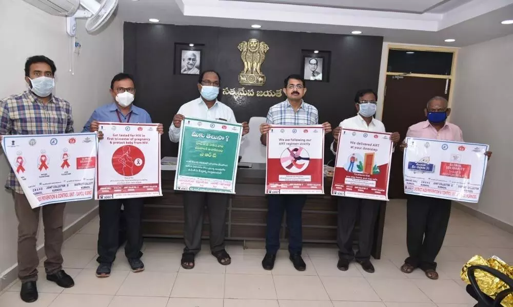 Joint Collector Rama Sunder Reddy and the staff of medical department launching the posters on AIDS in Kurnool on Monday