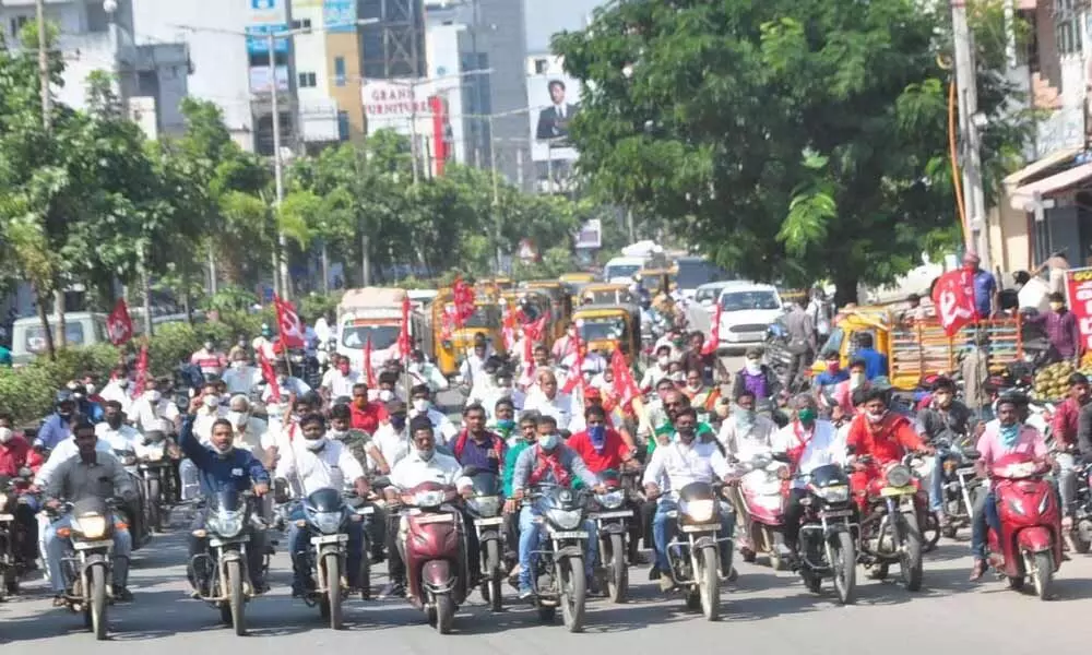 CPM leaders and activists taking out a motorcycle rally in Khammam on Monday