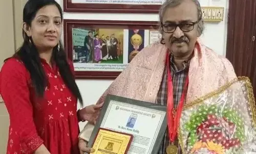 Dr Manasa presenting a certificate and memento to her father Dr Karri Rama Reddy on behalf of Khammam Psychiatric Society on Monday