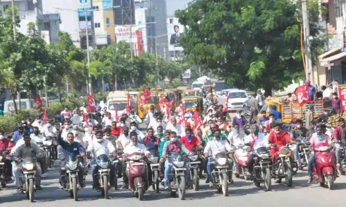 CPM leaders and activists taking out a motorcycle rally in Khammam on Monday