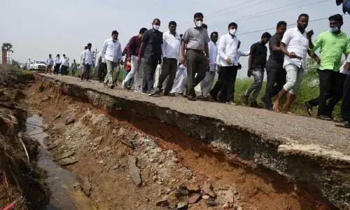 District Collector K V N Chakradhar Babu inspecting a damaged road in Bogole mandal on Tuesday. Kavali MLA MLA R Prathap Kumar Reddy is also seen.