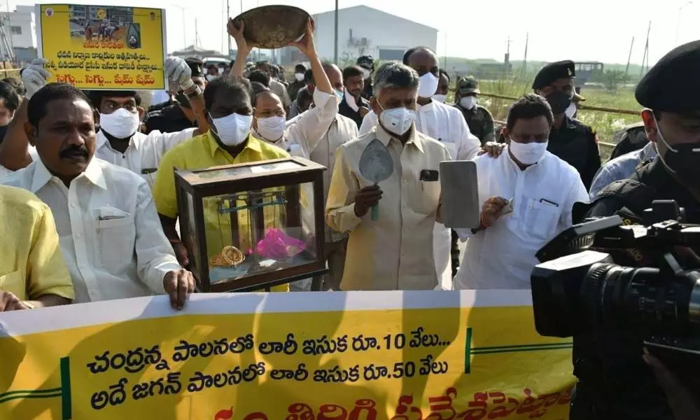 TDP president N Chandrababu takes part in a rally holding tools of construction workers to highlight their plight at Assembly on Wednesday