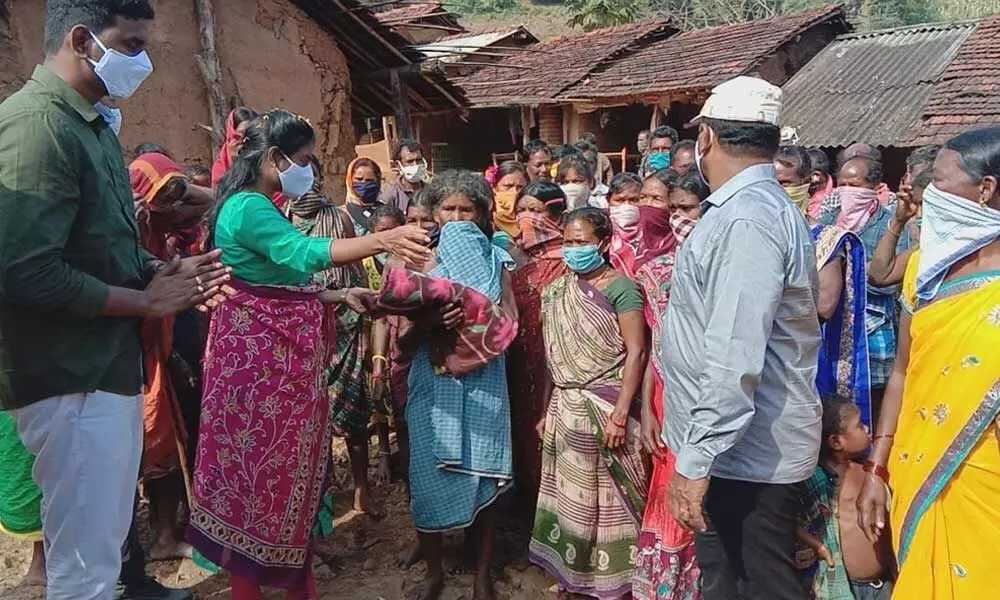 Superintendent of Police B Rajakumari distributing blankets to tribes in Erra Samantha Valada on Thursday