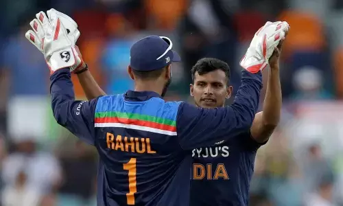 India’s Thangarasu Natarajan (right) is congratulated by teammate Indias K.L. Rahul after bowling Australia’s Marnus Labuschagne for 7 runs during their ODI match at Manuka Oval in Canberra, Australia on Wednesday