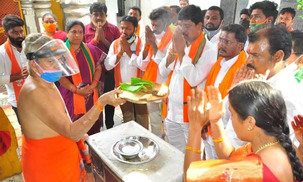 District BJP chief Galla Satyanarayana along with party activists offering prayers at Narasimha Swamy temple in Khammam on Friday