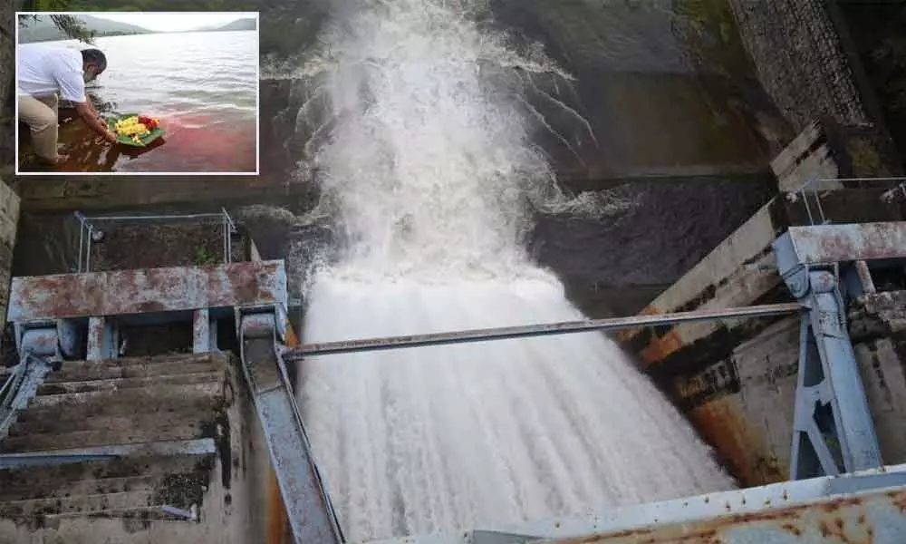 Water gushing out from Kalyani dam after a crest gate opened on Saturday. (Inset) Chandragiri MLA and TUDA Chairman Chevireddy Bhaskar Reddy offering Jala Harathi at Kalyani dam, in Tirupati on Saturday