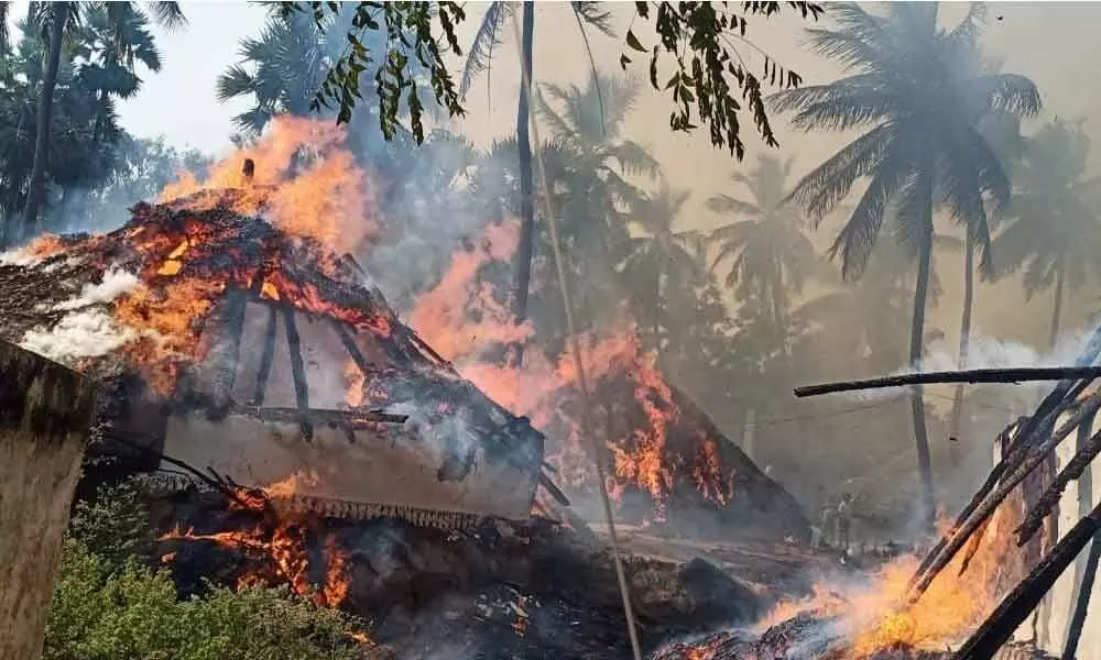 Thatched houses which caught fire at Chintapalli village in Pusapatirega mandal in Vizianagaram district on Saturday